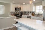 The beautiful new counter tops transforms the kitchen island breakfast bar into a fine dining experience